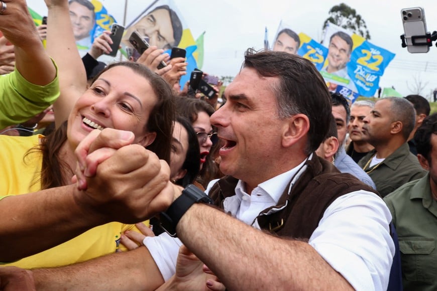 Brazilian presidential candidate Flavio Bolsonaro of the Liberal Party (PL) campaigns in the Sarandi neighborhood, one of the areas hardest hit by the historic floods in 2024, in Porto Alegre, Brazil, October 14, 2026. REUTERS/Diego Vara