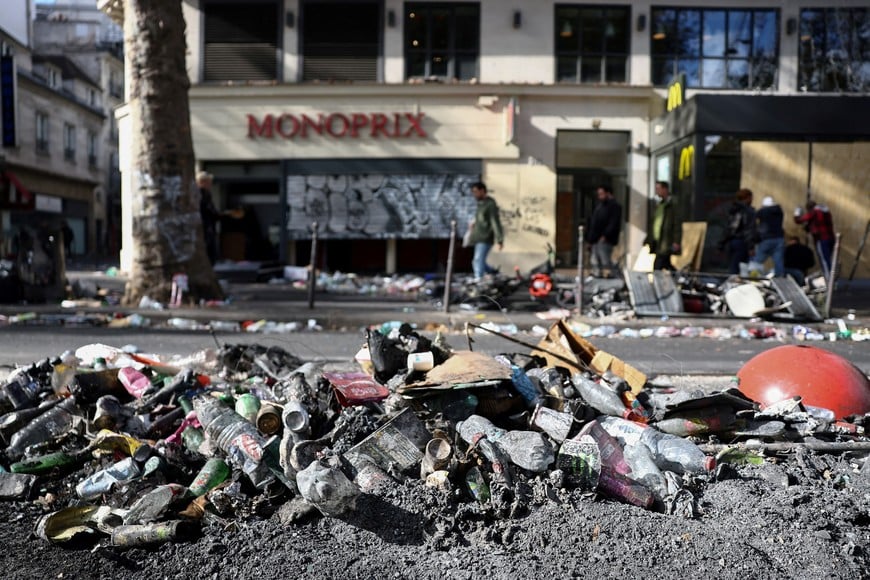 Ashes and rubbish on the side of a street, the day after clashes during a national day of demonstrations against the cost of living and rising fuel prices, in Paris, France, October 18, 2026. REUTERS/Abdul Saboor