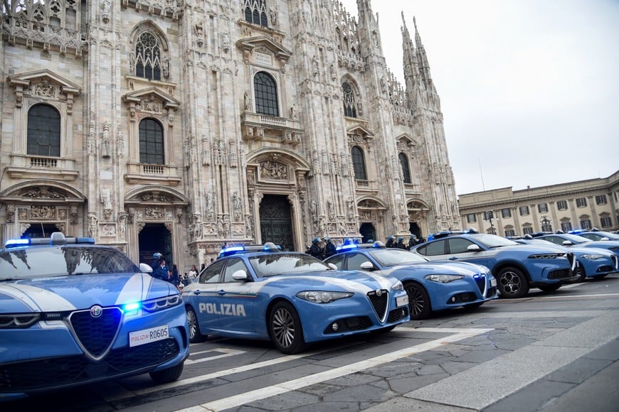 Italian police vehicles sit deployed outside the Duomo cathedral following clashes between police and demonstrators protesting the state of public services and the rising cost of living in Milan, Italy, October 18, 2026. REUTERS/Stringer