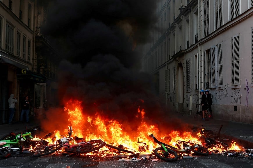 FILE PHOTO: Bicycles burn during civil unrest, the day after a national day of demonstrations against the cost of living and rising fuel prices, in Paris, France, October 18, 2026. REUTERS/Abdul Saboor/File Photo