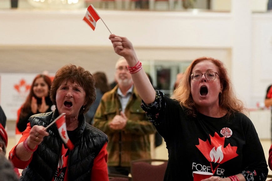 Supporters of the Forever Canadian group, who want Alberta to remain in Canada, wave Canadian flags as they watch the results of a non-binding referendum on Alberta sovereignty in Edmonton, Alberta, Canada October 19, 2026. REUTERS/Todd Korol