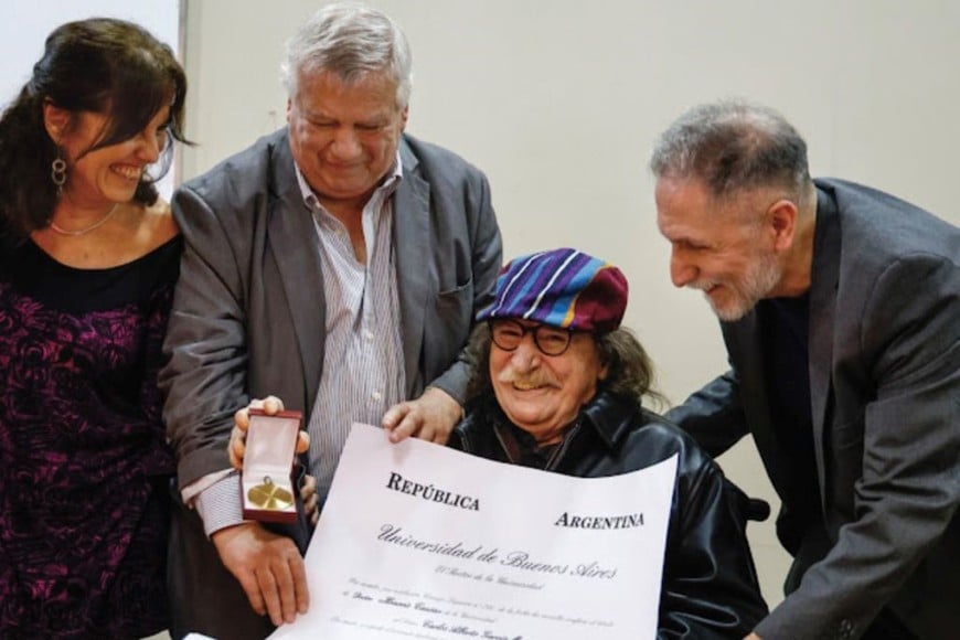 DOCTOR CHARLY GARCÍA. La vicedecana, Graciela Morgade, el rector, Ricardo Gelpi, y el decano de la Facultad de Filosofía y Letras, Ricardo Manetti, le entregan a Charly García el diploma que lo acredita como Doctor Honoris Causa por la Universidad de Buenos Aires.