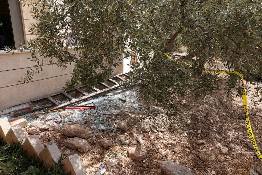Cordon tapes on a tree outside Saint George’s Greek Orthodox Church, where gunmen opened fire during a funeral the previous day, in the village of Hamoud, Karak, Jordan, October 24, 2026. REUTERS/Alaa Al Sukhni
