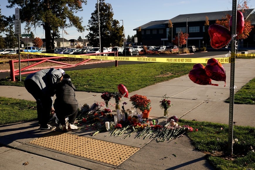 People leave objects at a makeshift memorial near a cordoned-off area following a shooting at Silver Rail Elementary School in Bend, Oregon, US, October 16, 2026. REUTERS/David Ryder