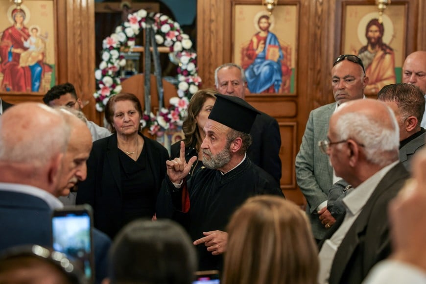 Father Theodoros Soueiss, priest of St. George’s Greek Orthodox Church, recounts to members of his congregation what happened during the deadly church shooting, in the village of Hamoud in Karak, Jordan, October 26, 2026. REUTERS/Alaa Al Sukhni