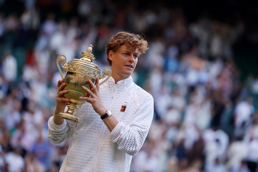 FILE PHOTO: Tennis - Wimbledon - All England Lawn Tennis and Croquet Club, London, Britain - July 12, 2026
Italy's Jannik Sinner celebrates with the trophy after winning his final match against Germany's Alexander Zverev REUTERS/Andrew Couldridge/File Photo