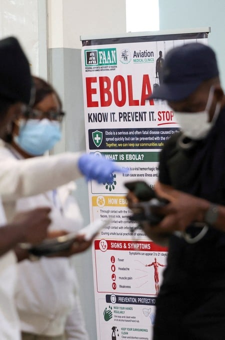 FILE PHOTO: A health official checks travellers' information at a health screening station at Murtala Muhammed International Airport following reports of an Ebola case in Nigeria, in Lagos, Nigeria, October 22, 2026. REUTERS/Sodiq Adelakun/File Photo