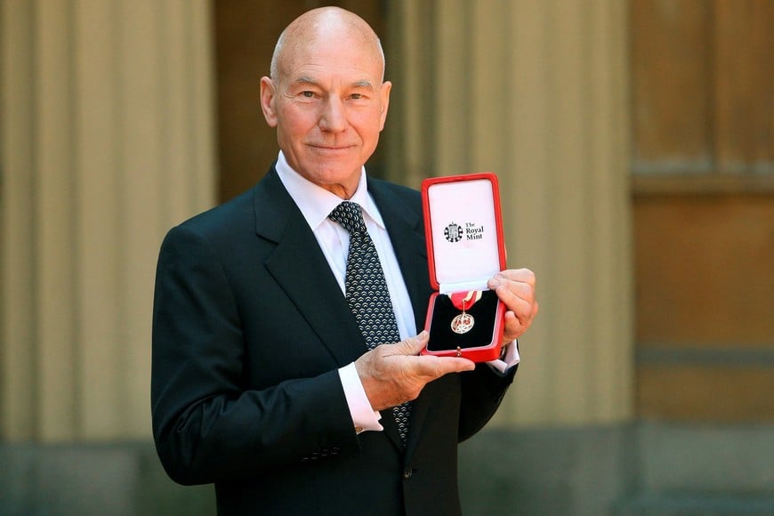 FILE PHOTO: Actor Patrick Stewart poses with his knighthood after he was knighted by Britain's Queen Elizabeth at Buckingham Palace in London June 2, 2010. REUTERS/Dominic Lipinski/Pool/File Photo