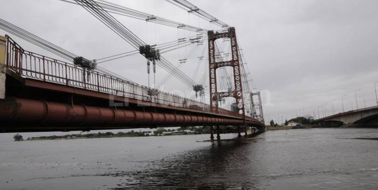 El agua está a centímetros de cubrir las pilas del Puente Colgante
