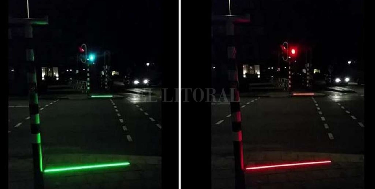Semáforos de led en el suelo para los peatones que miran el celular