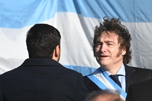 Después del acto compartido en Rosario por el día de la Bandera, Milei y Pullaro (de espaldas) se volverán a dar la mano este lunes a la noche. El gobernador santafesino celebró por estos días la incorporación de la educación entre los puntos que componen el Pacto de Mayo que se firmará en Tucumán. Crédito: Mauricio Garín