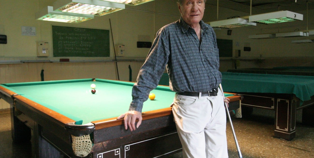Un hombre, un cigarrillo, una mesa de billar